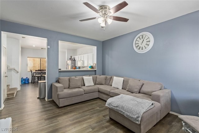 living room featuring dark hardwood / wood-style flooring and ceiling fan