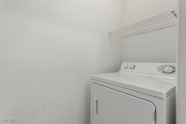 clothes washing area featuring laundry area and washer / clothes dryer