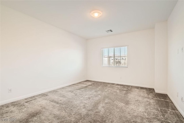 spare room with dark carpet