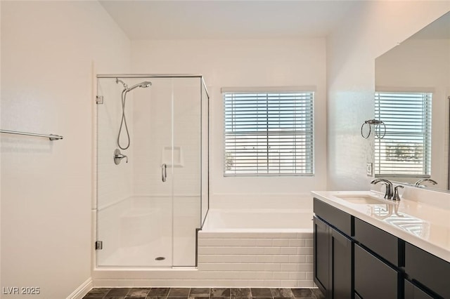 bathroom featuring vanity, shower with separate bathtub, and a wealth of natural light