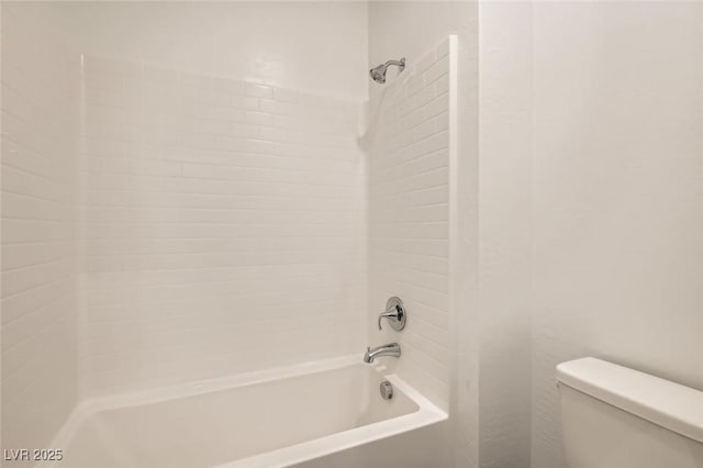 bathroom featuring bathing tub / shower combination and toilet