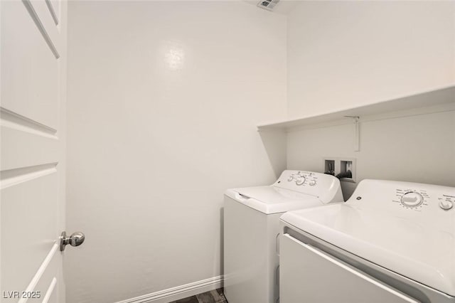 clothes washing area featuring washing machine and dryer and hardwood / wood-style floors