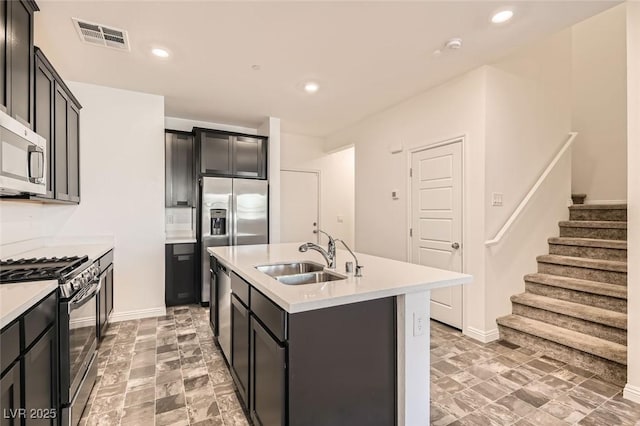 kitchen featuring a center island with sink, sink, and appliances with stainless steel finishes