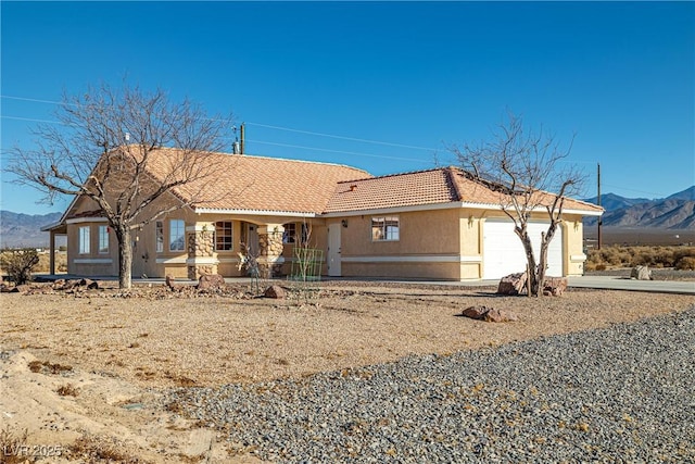 view of front of house with a mountain view and a garage