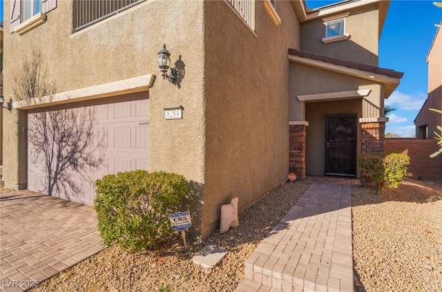 doorway to property with a garage