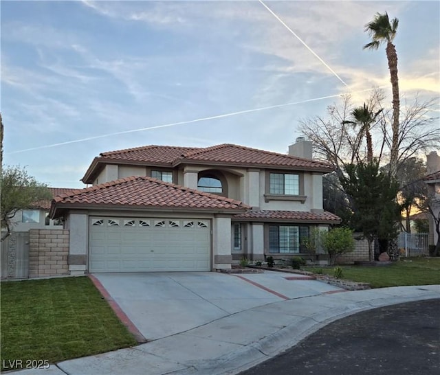 mediterranean / spanish-style home with a garage and a yard