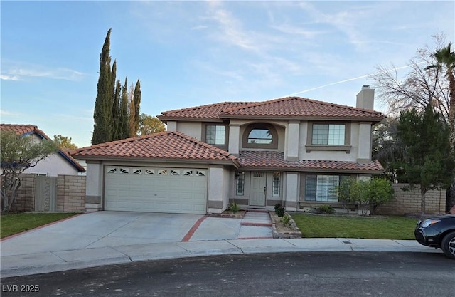 mediterranean / spanish house with a garage