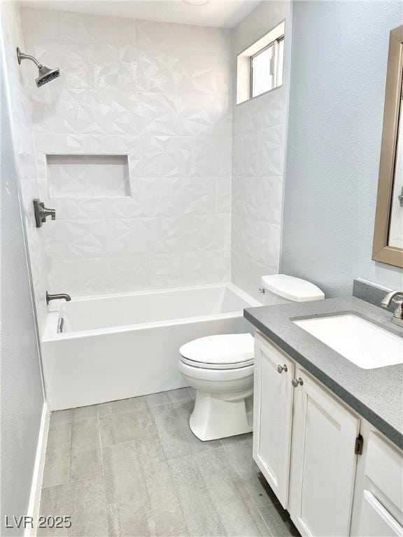 full bathroom featuring vanity, toilet, and tiled shower / bath