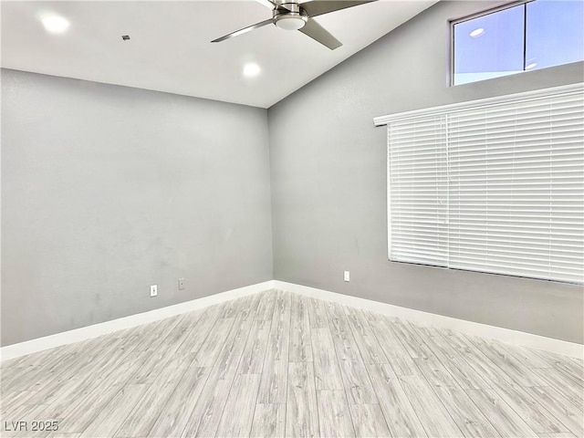 unfurnished room with ceiling fan, light wood-type flooring, and lofted ceiling