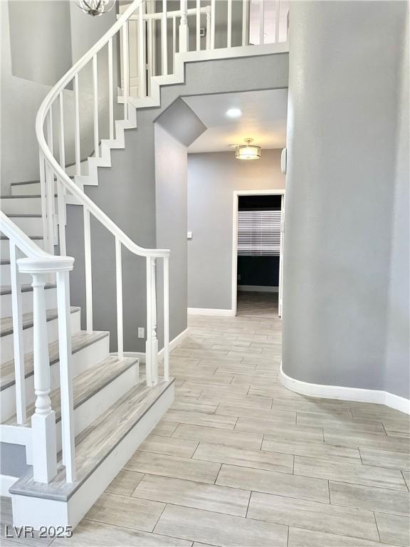 stairs featuring a towering ceiling