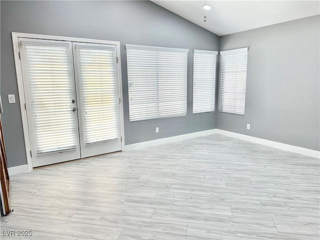 unfurnished room with lofted ceiling