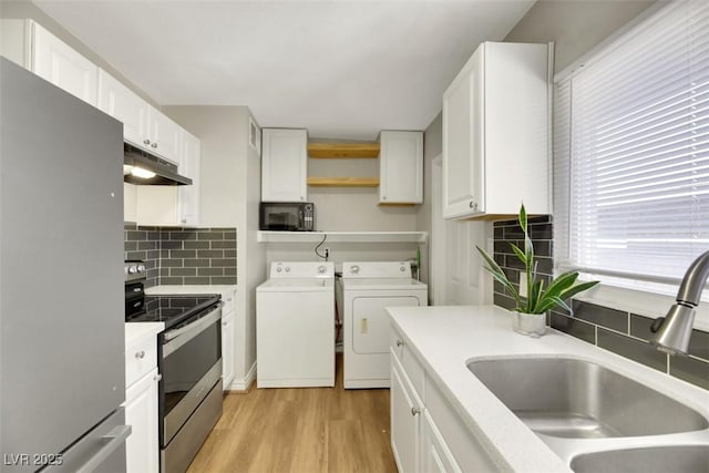 kitchen featuring white cabinetry, sink, separate washer and dryer, and stainless steel appliances