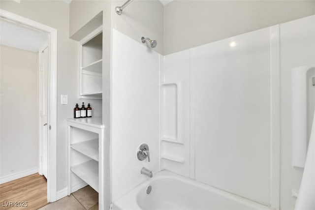 bathroom with shower / bath combination and tile patterned floors