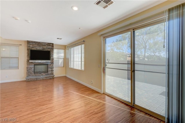 unfurnished living room featuring a fireplace and wood-type flooring