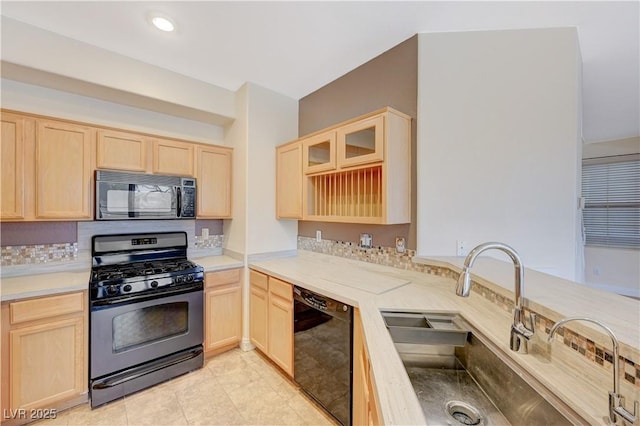 kitchen featuring sink, light brown cabinets, and black appliances