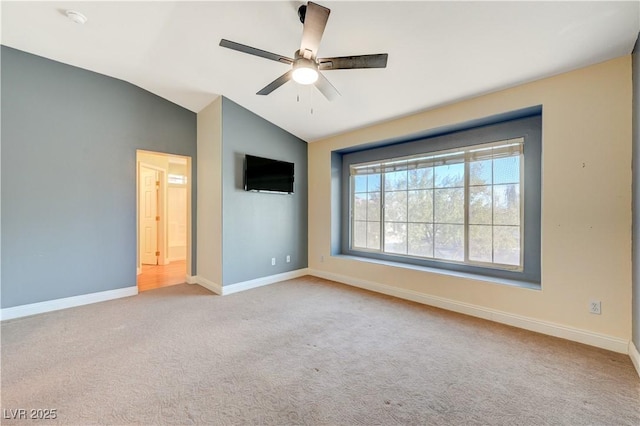 unfurnished bedroom with ceiling fan, vaulted ceiling, and light carpet