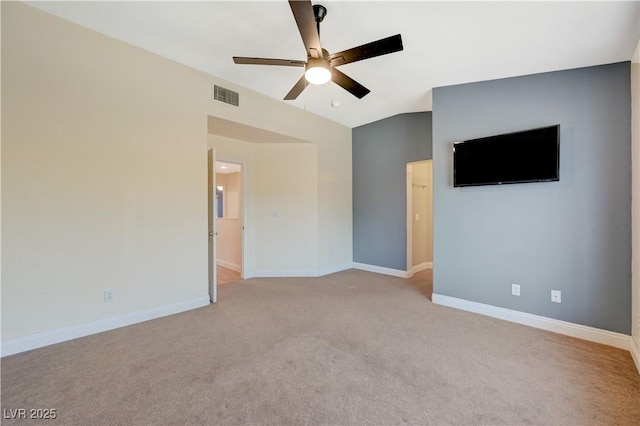 spare room with light colored carpet, ceiling fan, and vaulted ceiling