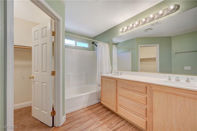 bathroom with vanity, hardwood / wood-style floors, and shower / bath combo