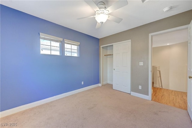 unfurnished bedroom featuring light carpet, ceiling fan, and a closet