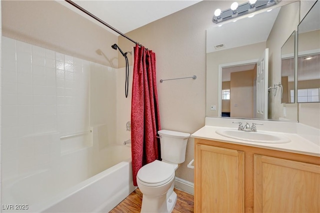 full bathroom with shower / tub combo, vanity, hardwood / wood-style floors, and toilet