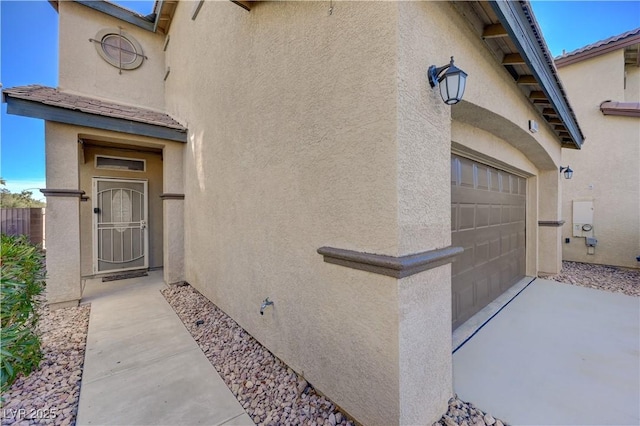 view of exterior entry featuring a garage