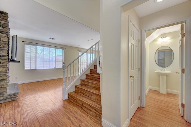 staircase with hardwood / wood-style flooring