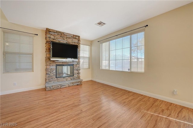 unfurnished living room featuring a fireplace and hardwood / wood-style floors