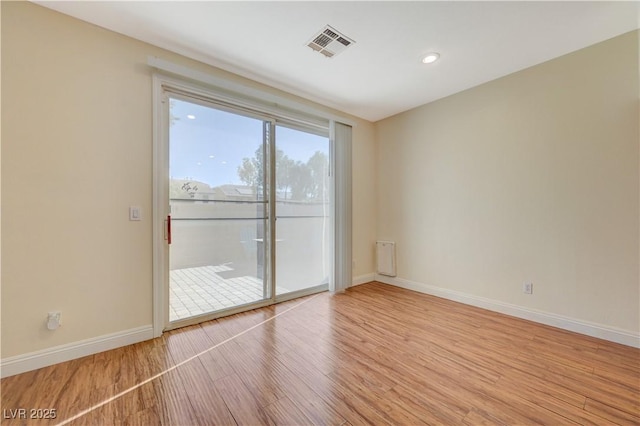 unfurnished room with light hardwood / wood-style flooring