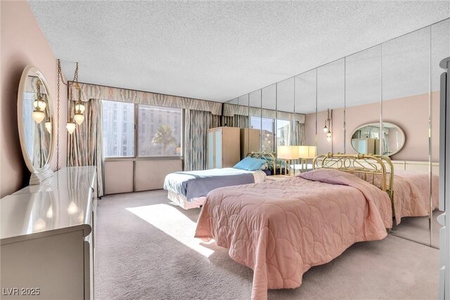 carpeted bedroom with a textured ceiling