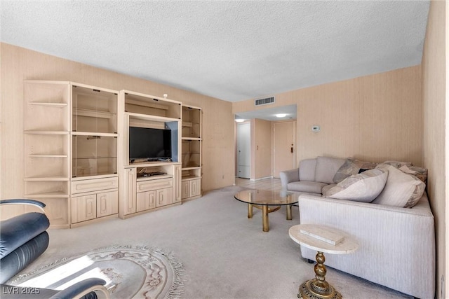 living room featuring light carpet and a textured ceiling