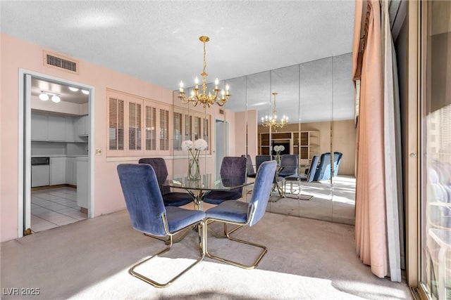 carpeted dining space featuring a textured ceiling and an inviting chandelier