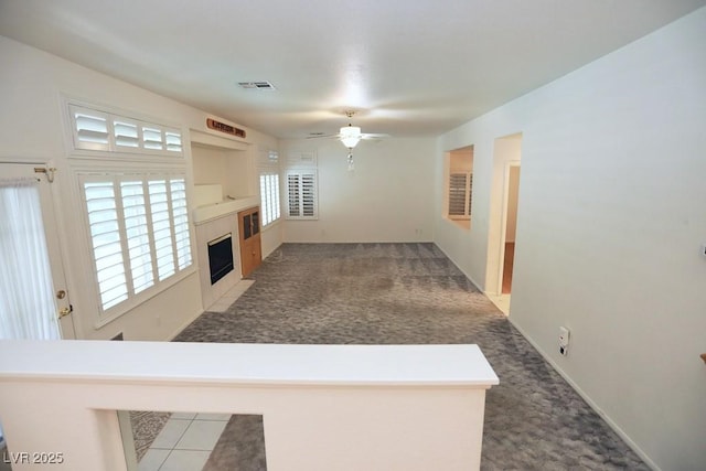 carpeted living room with ceiling fan