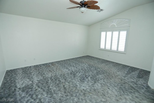 carpeted empty room featuring vaulted ceiling and ceiling fan