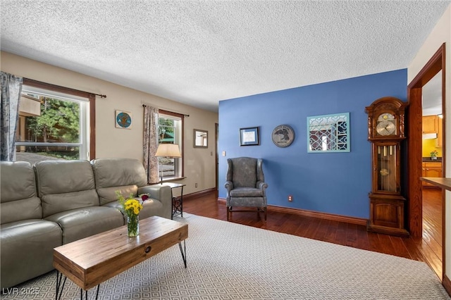 living room with dark wood-type flooring and a textured ceiling