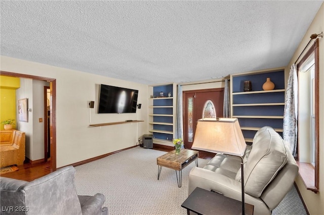 living room featuring carpet flooring, built in features, and a textured ceiling