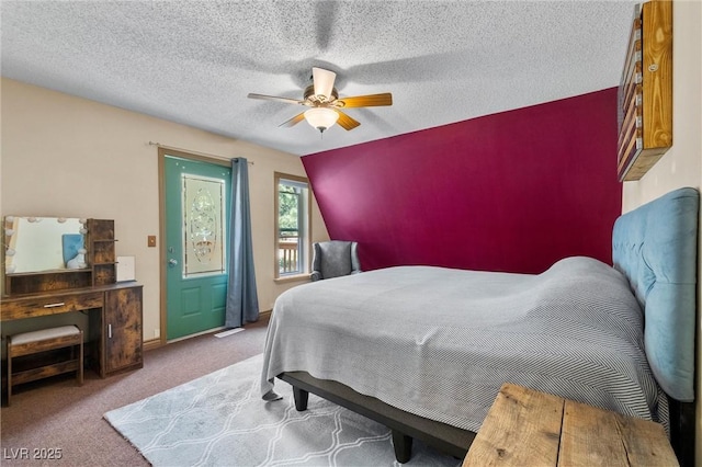 carpeted bedroom with a textured ceiling, ceiling fan, and lofted ceiling