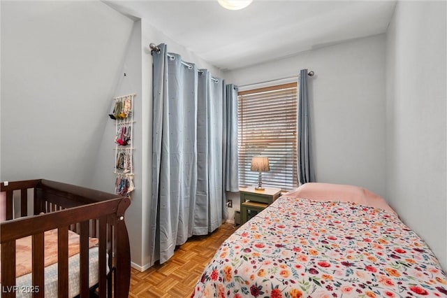 bedroom featuring light parquet flooring