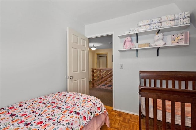 bedroom featuring parquet flooring