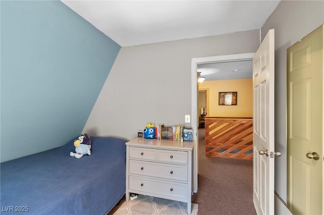 carpeted bedroom with wood walls