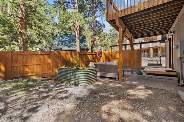 view of yard featuring a deck and a patio