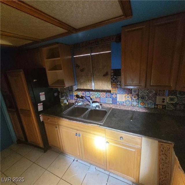 kitchen featuring light tile patterned floors, sink, and tasteful backsplash