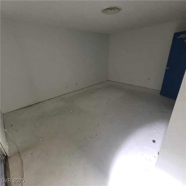 unfurnished room featuring concrete flooring