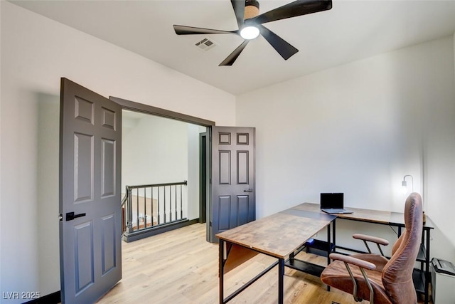 office with ceiling fan and light hardwood / wood-style flooring