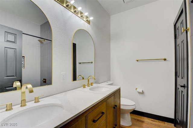 bathroom with vanity, wood-type flooring, and toilet