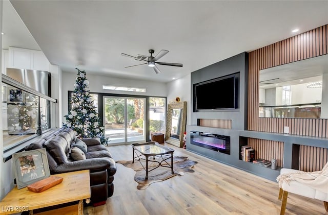 living room with ceiling fan and wood-type flooring