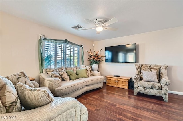 living room with dark hardwood / wood-style flooring and ceiling fan