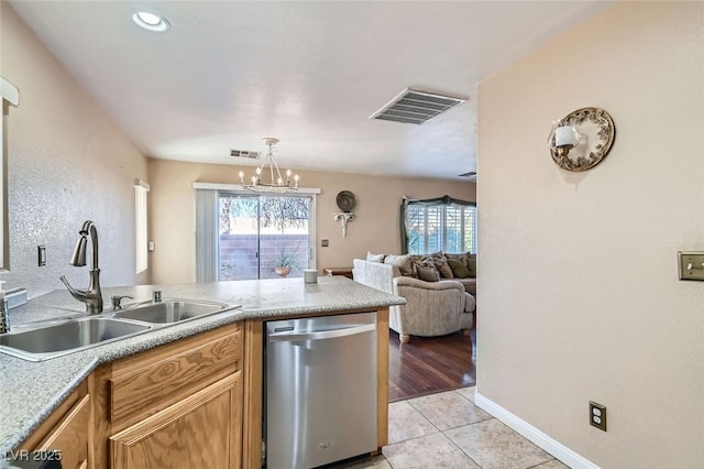 kitchen featuring sink, stainless steel dishwasher, a chandelier, decorative light fixtures, and light tile patterned floors