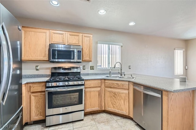 kitchen featuring sink, stainless steel appliances, kitchen peninsula, light brown cabinetry, and light tile patterned flooring