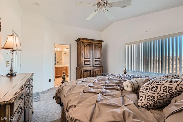 bedroom with ensuite bath, ceiling fan, light colored carpet, and lofted ceiling