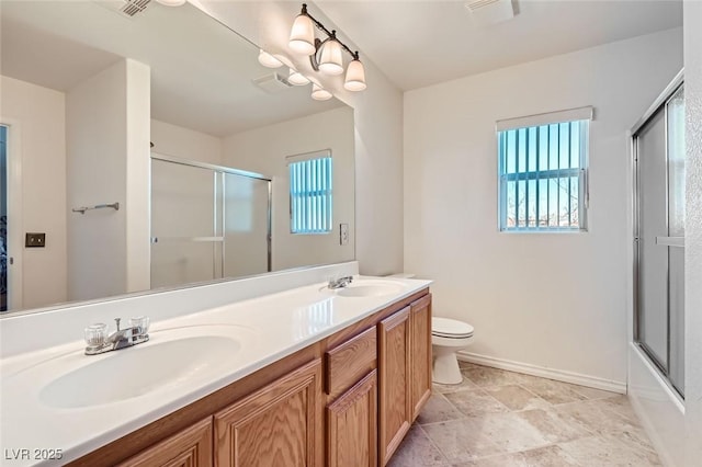 full bathroom featuring a chandelier, vanity, toilet, and bath / shower combo with glass door